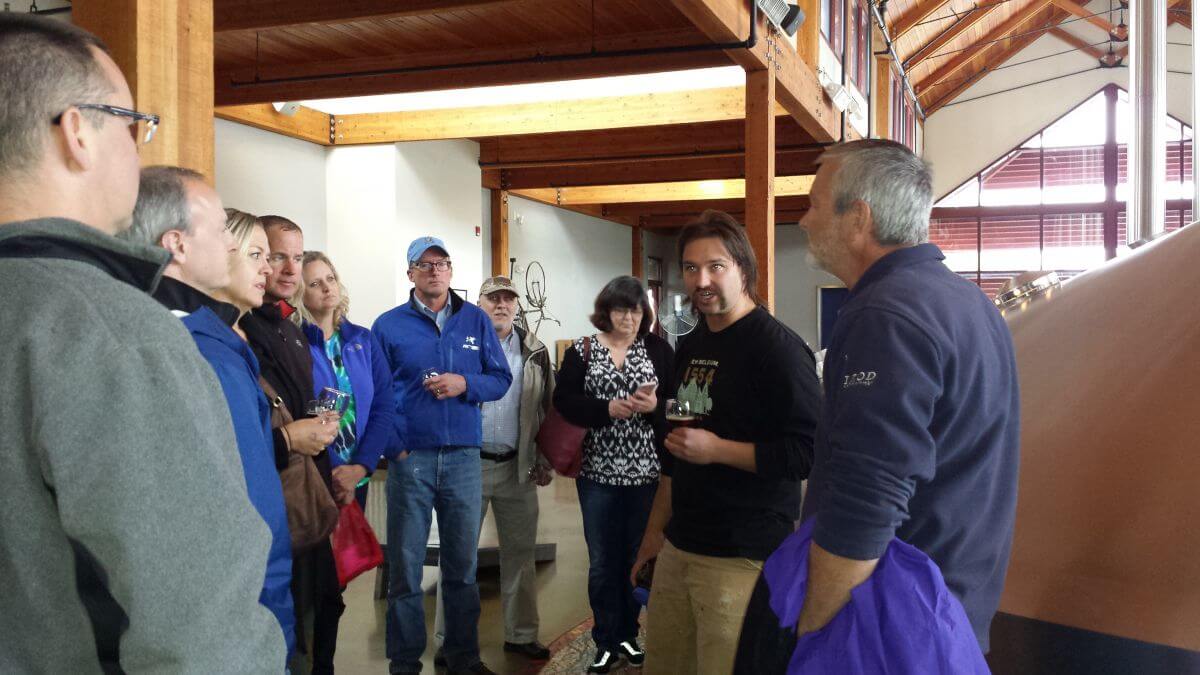 Image of conference attendees at a brewery