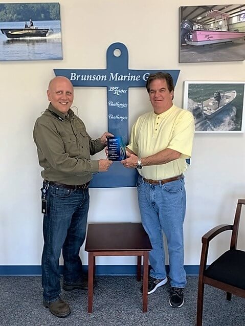 Tony Pendola, North Carolina Department of Environmnetal Quality Small Business Ombudsman handing Bob Brunson, Owner of Brunson Marine Group, the Small Business Environmental Stewardship Award.