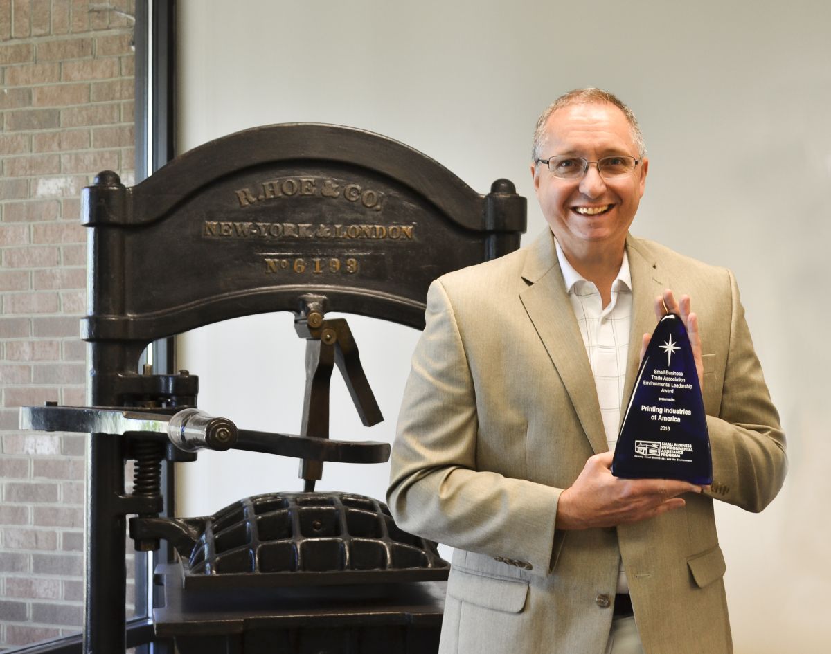 Image of Printing Industries of America employee receiving the Small Business Trade Association Environmental Leadership award. 