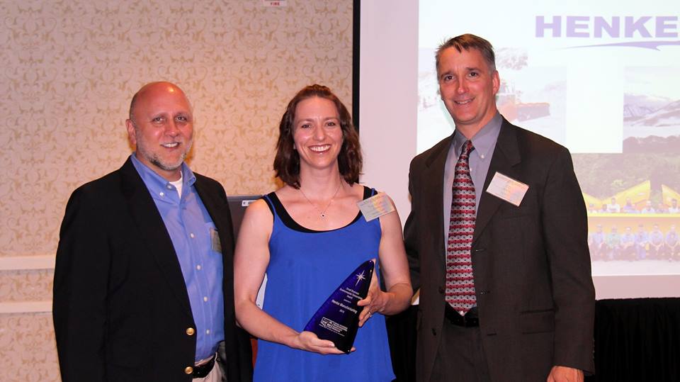 Image of Henke Manufacturing employee receiving the Small Business Environmental Stewardship Award on companies behalf.