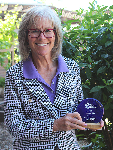 Nancy Larson holding NSBEAP award